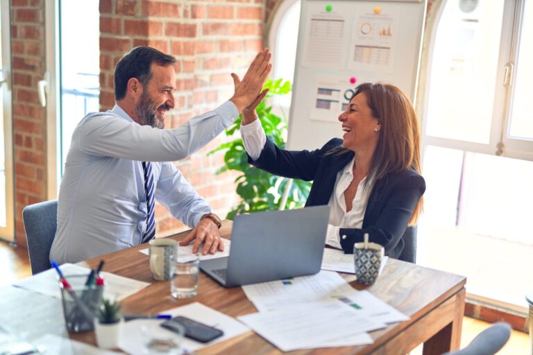 Lawyers high-fiving Man and woman high-fiving